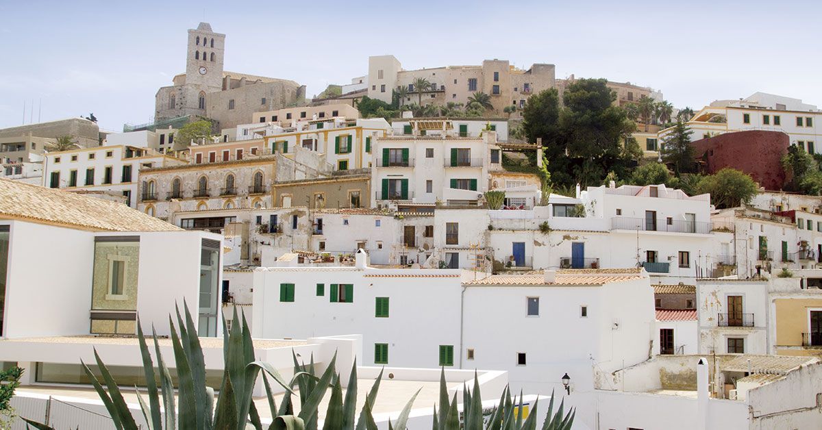 View of Dalt Vila in Ibiza, with whitewashed houses, Mediterranean architecture and the historic city rising above the old town.